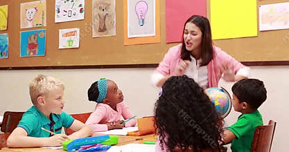 Teacher and pupils looking at globe