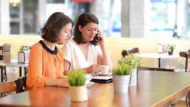 Two women at bar serving breakfast