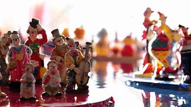 Figurines of Clowns on Floating Platform