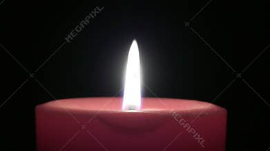 Red Candle With Flame Against Black Background