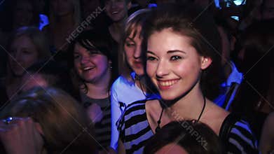 Very beautiful girl standing at the club. Stands