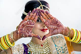 Indian Bride with Mehendi hands or Henna