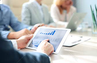 Group of businesspeople looking at graphs