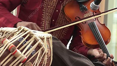 Indian man play music on Violin