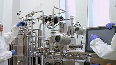 Scientists in protective suits working together