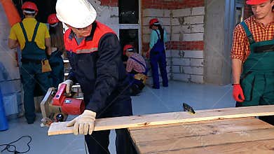 Man in builder helmet and uniform with electric