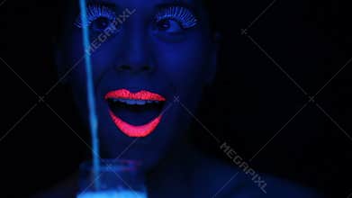 Woman face with fluorescent make up