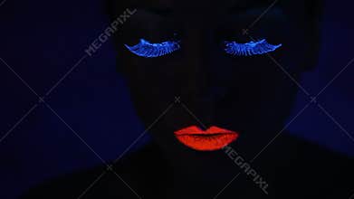 Woman face with fluorescent make up