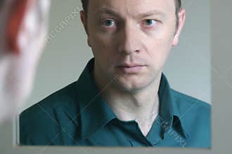 Man Looking in Mirror