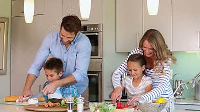 Attentive parents and their children cooking together