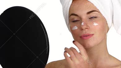 Woman applying cream on face. Close up. slow