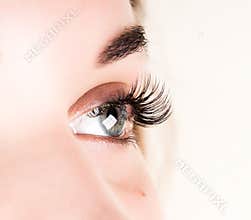 Beautiful young woman eyelash extension. Woman eye with long eyelashes. Beauty salon concept