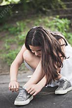 Teen girl binding shoelace