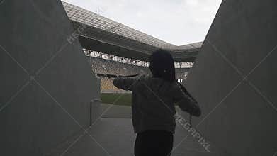 Silhouette of afro woman on the stadium with raised up hands in winner style. Win concept