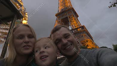 Family shooting selfie by Eiffel Tower, home video style