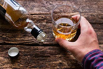 Alcoholic holding a glass of alcohol