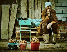 Old Russian woman selling potatoes Kaluga region.