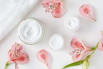 Herbal spa cosmetic cream with pink flowers hygienic skincare lotion