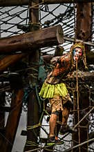 Super hero Competitor 2014 Tough guy obstacle race in fancy dress hanging on ropes