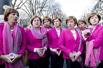 Group of young men posing as Angela Merkel on street carnival in Dusseldorf