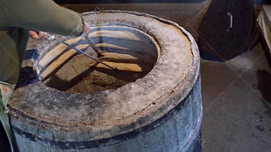 Woman gets out of the tandoor cooked traditional Georgian bread shoti