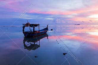 Sunrise by the beach with boat in George Town, Penang Malaysia