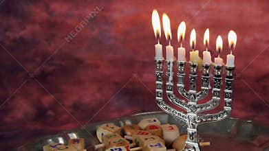 Jewish holiday hannukah symbols - menorah and wooden dreidels.