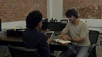 Man arrives for work on bike people office diverse mix race group