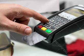 Credit or debit card password payment. Customer hand is entering
