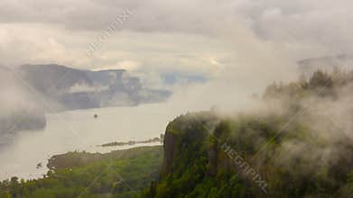 Time lapse of moving low clouds and fog along Columbia River Gorge and over historic Vista House in Portland OR 4k