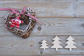 White red christmas decoration as christmas tree, reindeer and star on a old grey wooden planks background with empty copy space