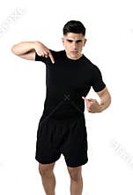 Attractive sport man pointing on his black t-shirt with copy space for adding gym fitness health club logo