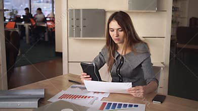 Young woman at the office talking with business partner on the touch screen tablet