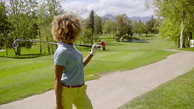 Young woman golfer with her club over her shoulder