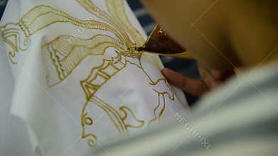 Waxing the patterns on the textile for batik