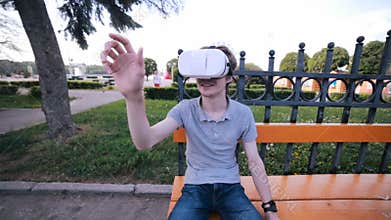 Young man watching 360 degree video virtual reality using VR glasses.
