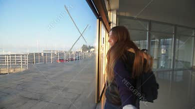 Girl taking viewer by hand and walking in building