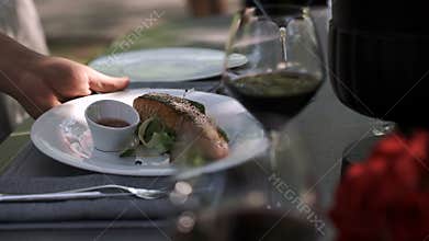 Catering. The waiter served the table for a delicious dinner.