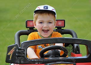 Little boy driving toy car
