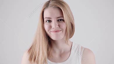 Young woman showing several emotion expressions, isolated on light grey background. Copy space text.