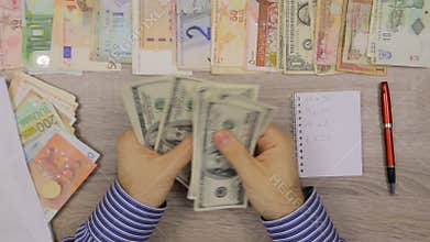 Banker counting Dollars at his office table,