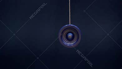 Playing the YOYO, close-up on a background of blue wall