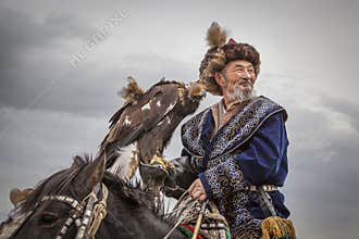 Mongolian nomad eagle hunter on his horse