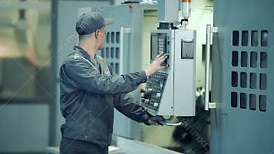 Industrial engineer worker operating control panel system at manufacture plant