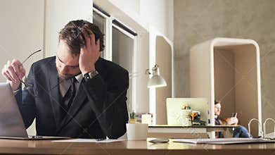 Tired Young Businessman Yawning During Work