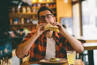 Man eating in a restaurant and enjoying delicious food