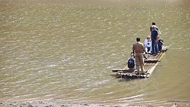 Caucasian Tourists Sail on Raft Guy Throws Rope across Lake