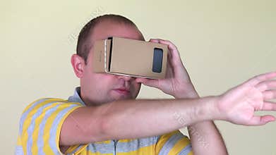 Man walking forward with vr virtual reality cardboard glasses