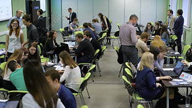 Audience Overview in university. Teams of students are actively working on the task.