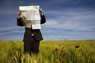 Businessman lost in field